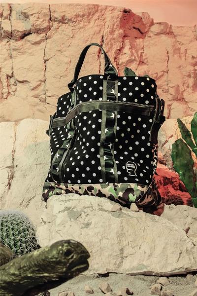 A bag placed in the natural history museum with a tortoise in the foreground. Brain Dead x Converse collaboration.