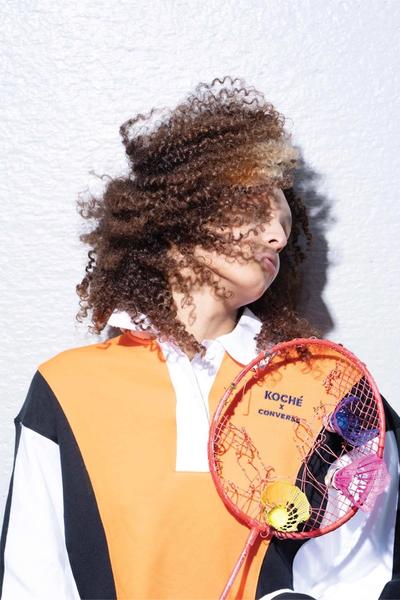 A photo of a black woman w beautiful curly hair in her face. Converse X Faith Connexion, Koché, Feng Chen Wang collaboration