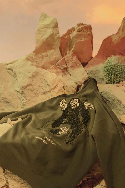A sweatshirt lying in the desert. Brain Dead x Converse collaboration.