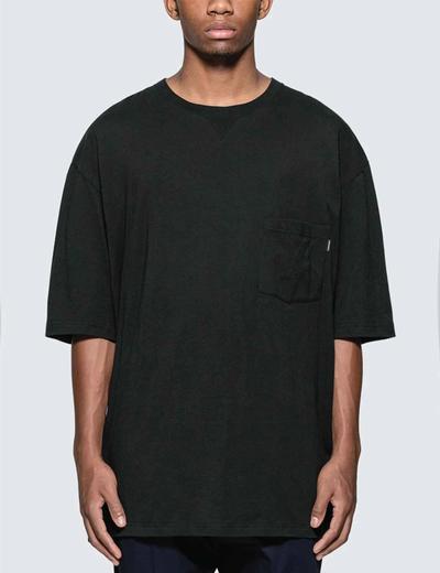 A man in a oversized tee. Soloist x Converse collaboration.