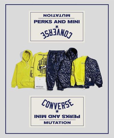 A collection of blue, yellow & white garments are laid flat in a row. Photo also features custom branding for the collab. Converse x P.A.M. (Perks and Mini) collab. 