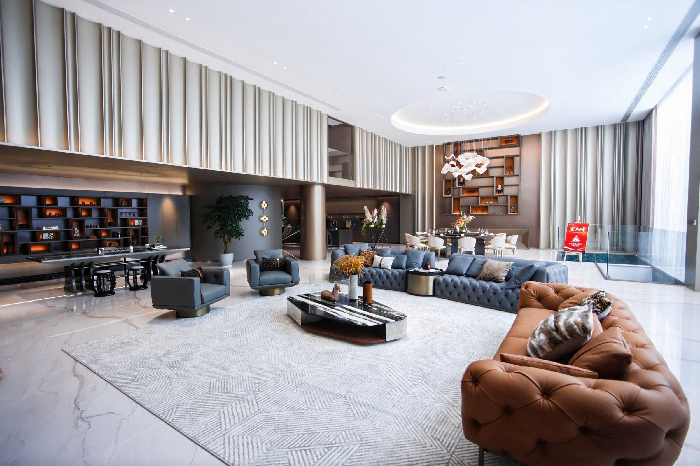 Full living-room composition with floor-to-ceiling cabinetry and integrated stainless steel display walls.