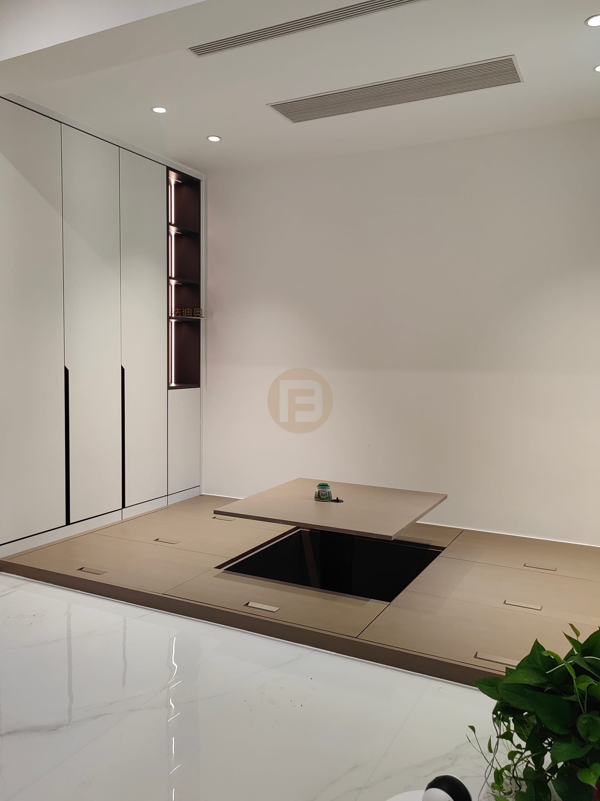 Raised tatami tea room with lift-up table and white cabinets with a lit display niche