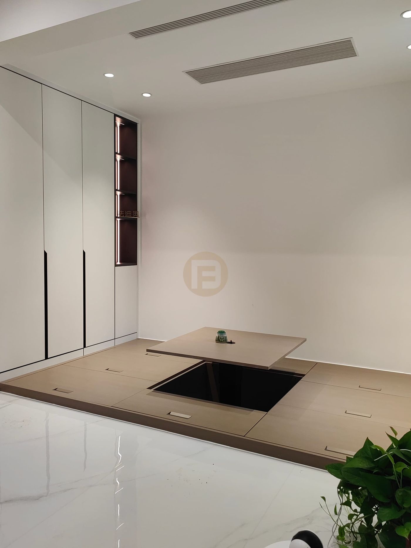 Raised tatami tea room with lift-up table and white cabinets with a lit display niche