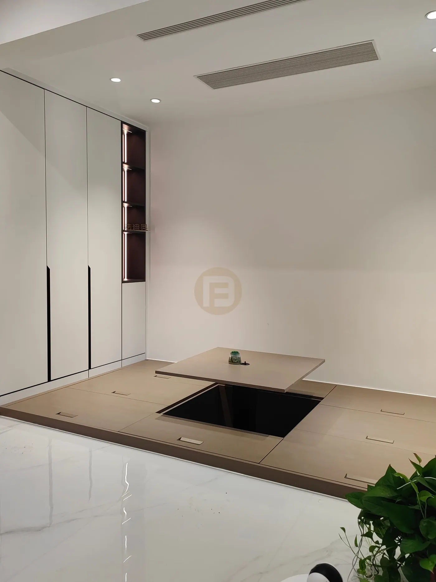 Raised tatami tea room with lift-up table and white cabinets with a lit display niche