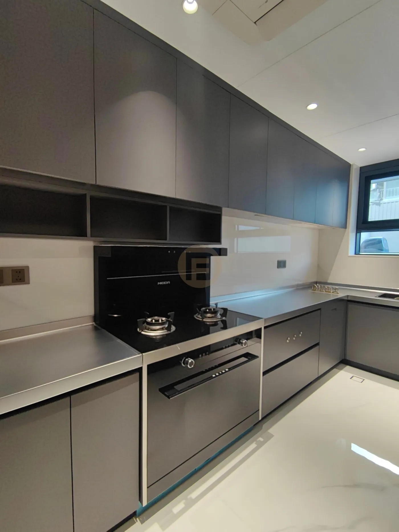 Graphite stainless steel cooking kitchen with seamless steel worktop, gas hob and integrated steam oven