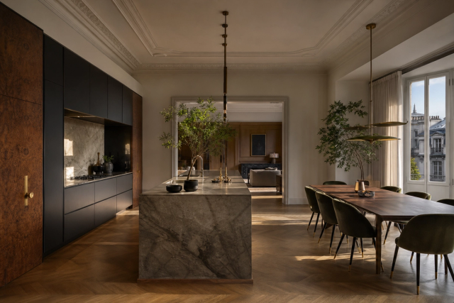 Fadior Milan 120 sqm Kitchen Penthouse — Milan kitchen penthouse with marble island, walnut cabinetry, parquet floor, dining table, window daylight, and brass lighting