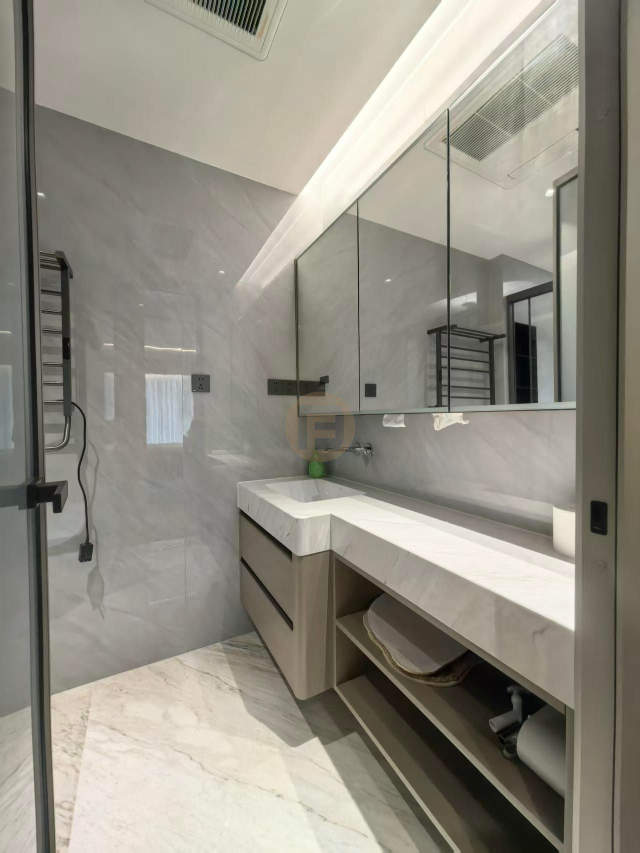 Marble-topped stainless steel bathroom vanity with mirrored cabinet and open towel shelf in a grey marble bathroom