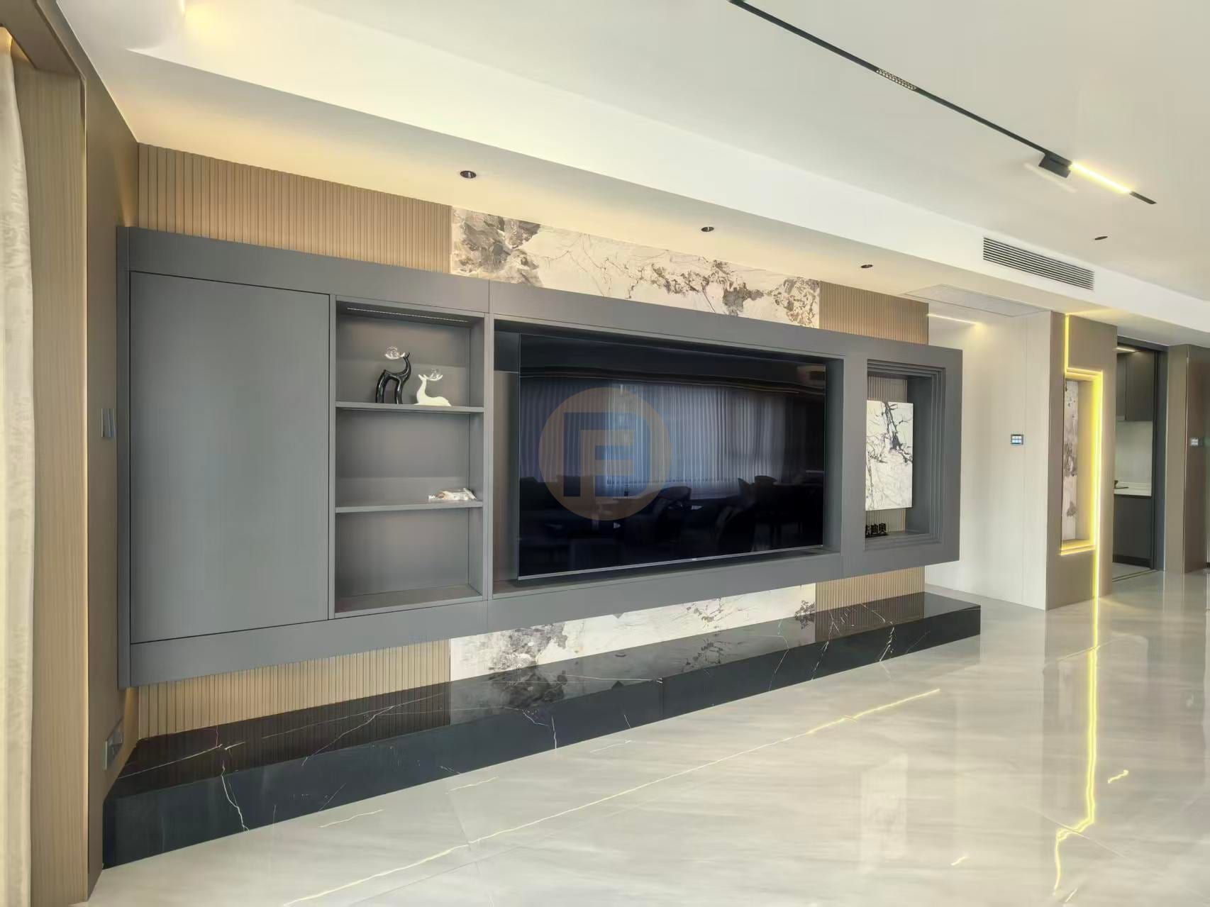 Charcoal-grey media wall with marble inserts, fluted oak panels and a black marble plinth in the living room