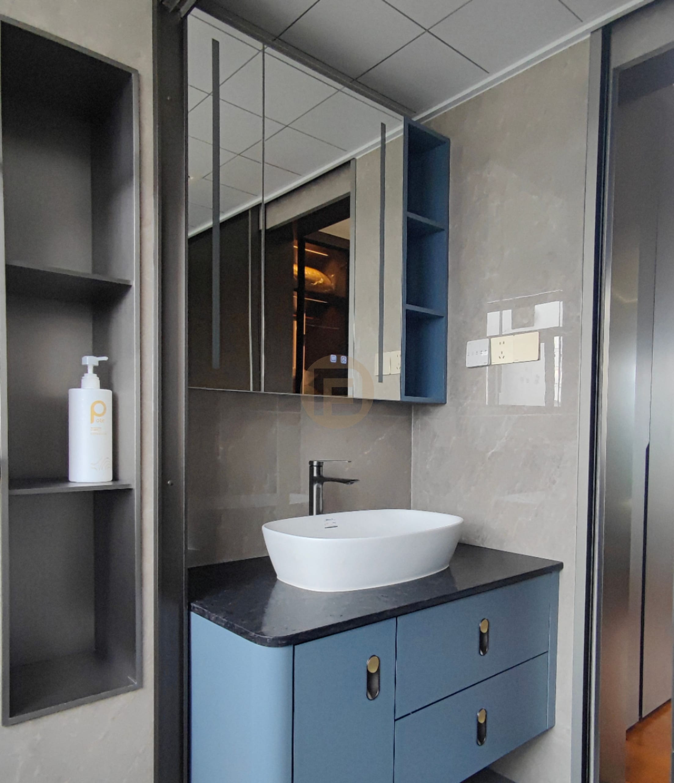 Blue lacquered stainless steel bathroom vanity with black stone top, countertop basin and mirrored cabinet