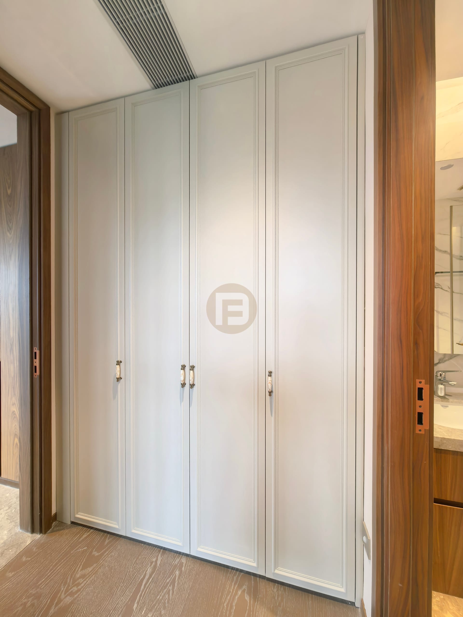 Framed off-white wardrobe doors set between walnut-toned door casings