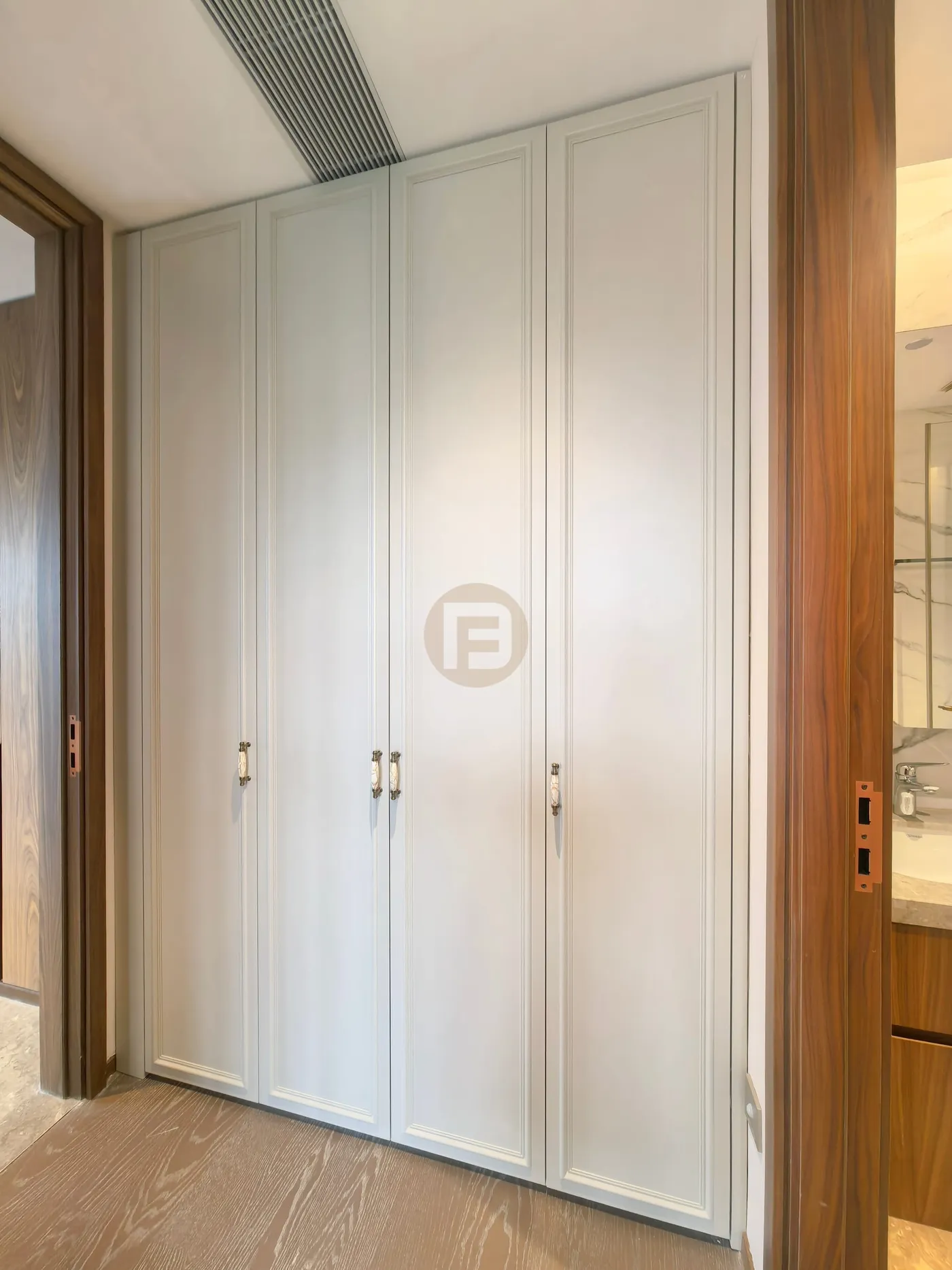 Framed off-white wardrobe doors set between walnut-toned door casings
