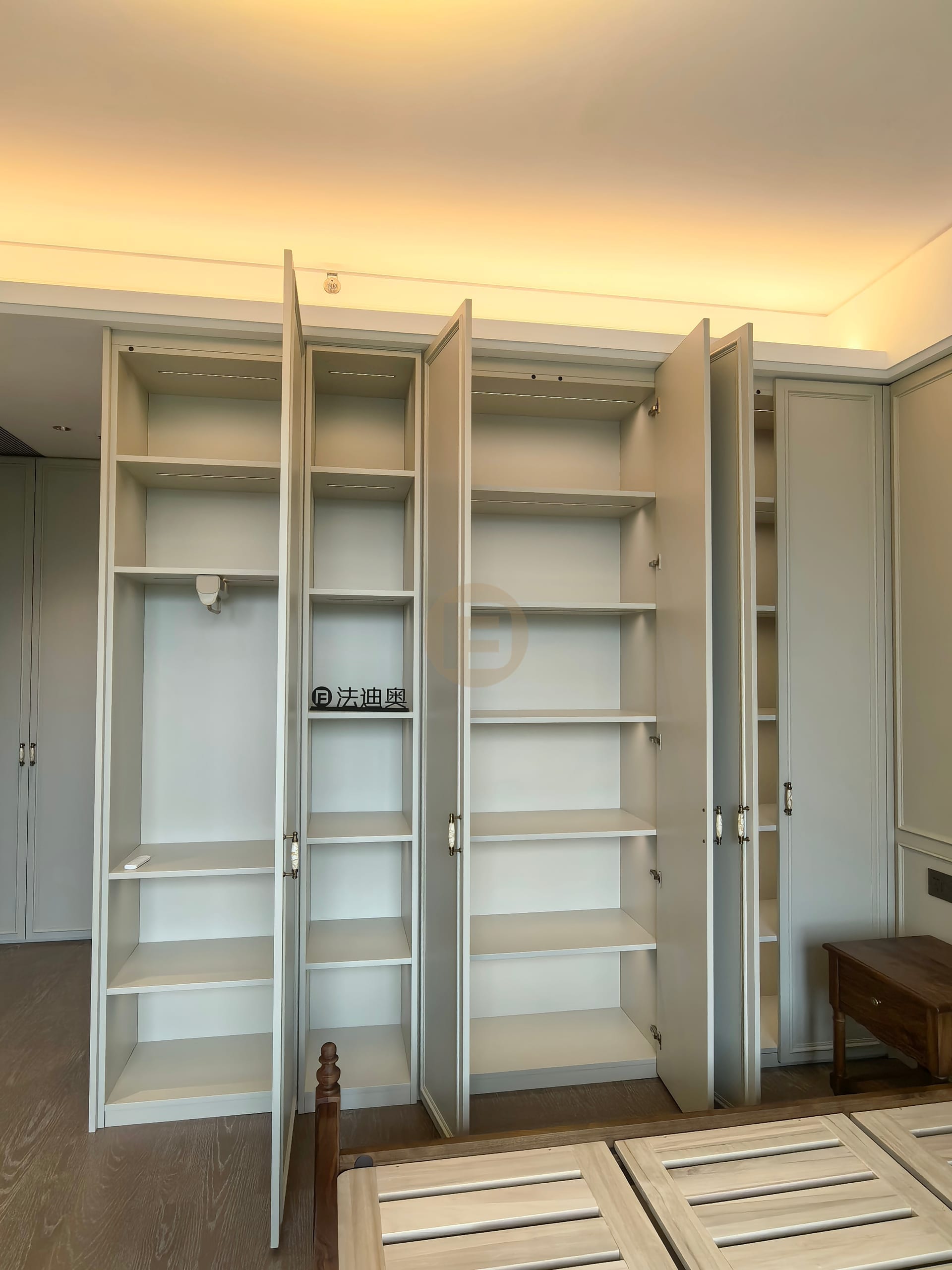 Opened bedroom wardrobes showing fully fitted stainless steel shelving interiors