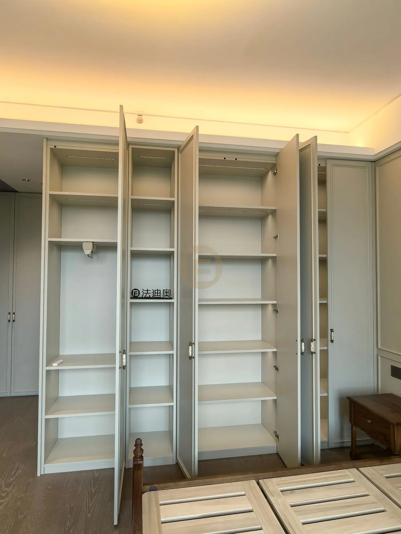 Opened bedroom wardrobes showing fully fitted stainless steel shelving interiors