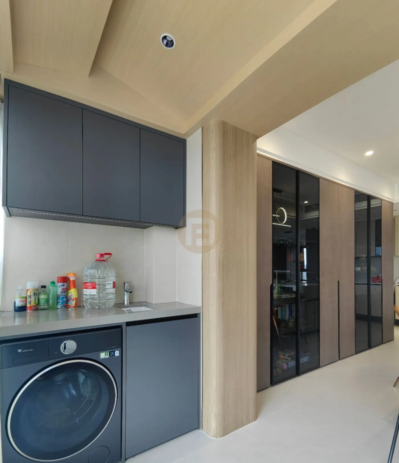 Slate-blue stainless steel balcony laundry cabinets with integrated washer and utility sink