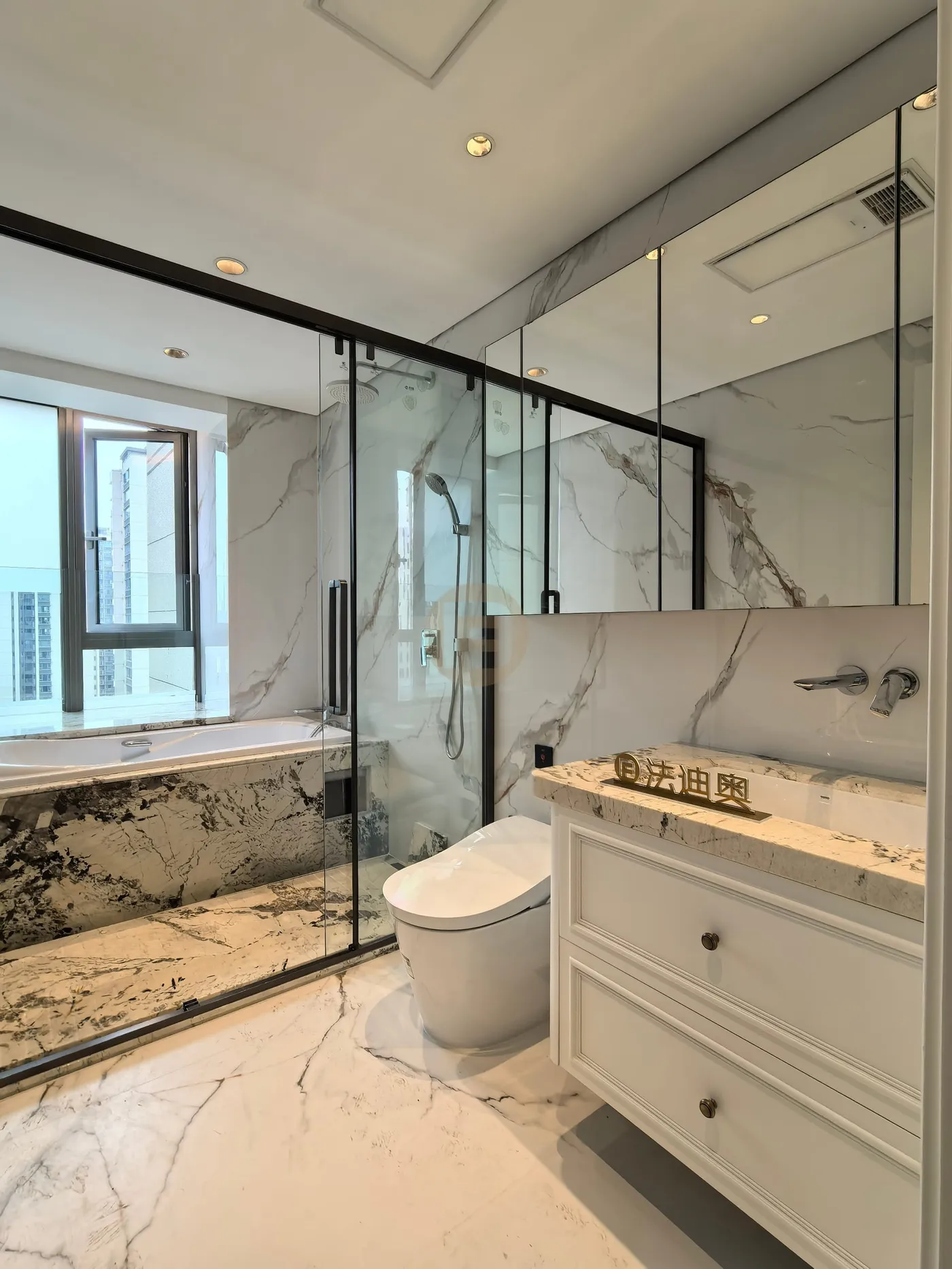 Marble bathroom with built-in tub, glass shower and white stainless steel vanity under a granite top