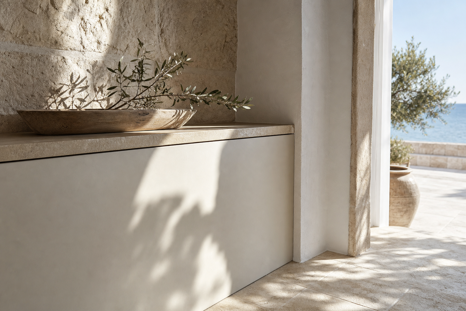 Kitchen material study with limestone, pale cabinetry, sea light, and matte surfaces for finish decisions.