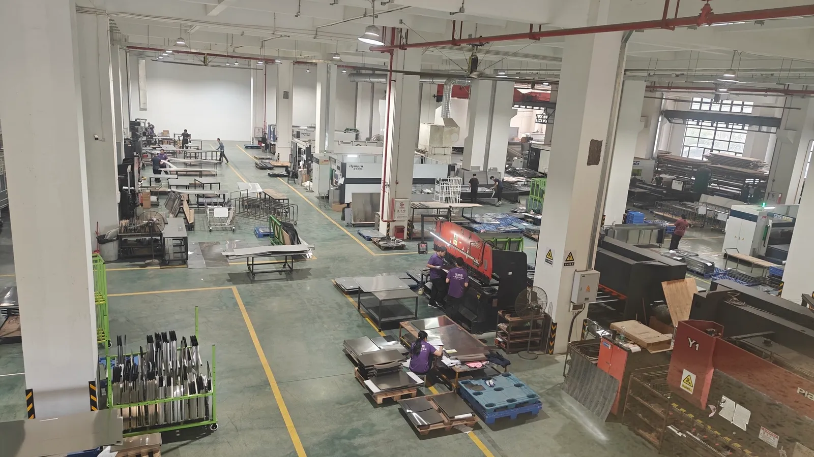 Wide production-floor overview showing multiple fabrication zones