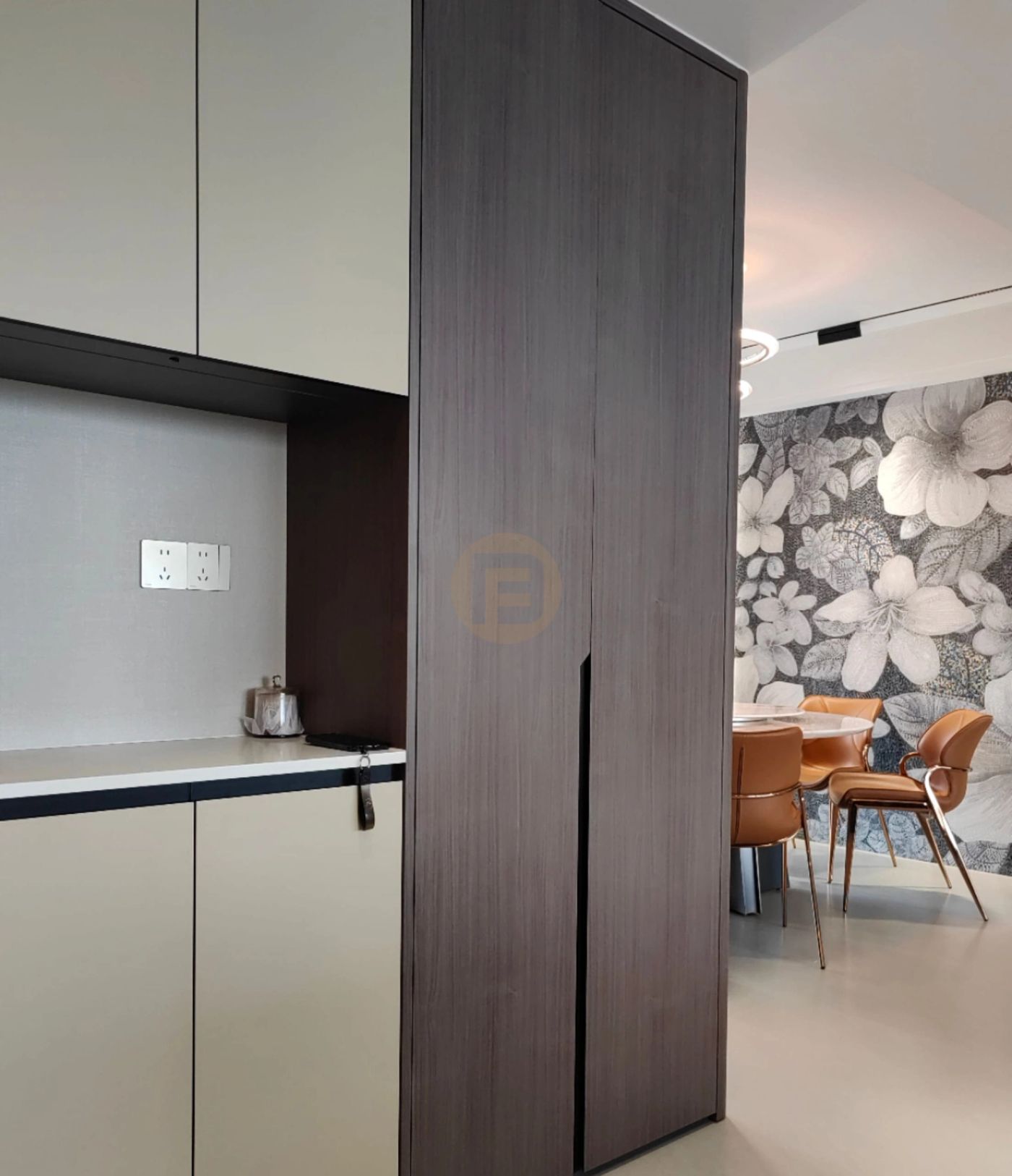 Champagne stainless steel service cabinets and a dark wood-grain column beside the floral-papered dining room