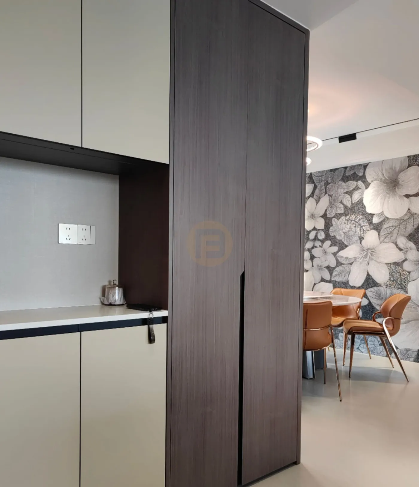 Champagne stainless steel service cabinets and a dark wood-grain column beside the floral-papered dining room