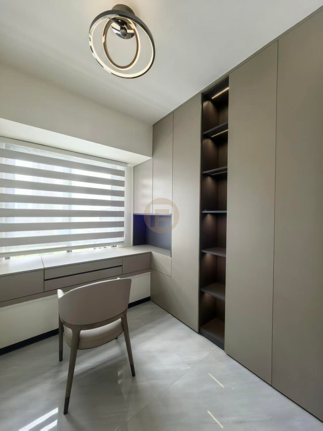 Fitted study with taupe cabinetry, a window-side desk and backlit open shelving