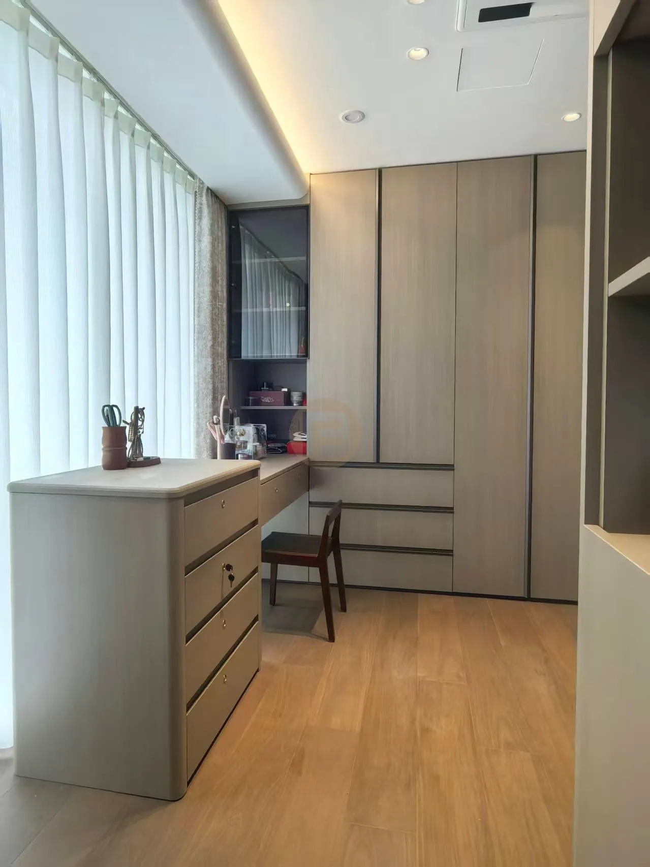 Dressing study with greige stainless steel wardrobes, built-in desk and chest of drawers by the window