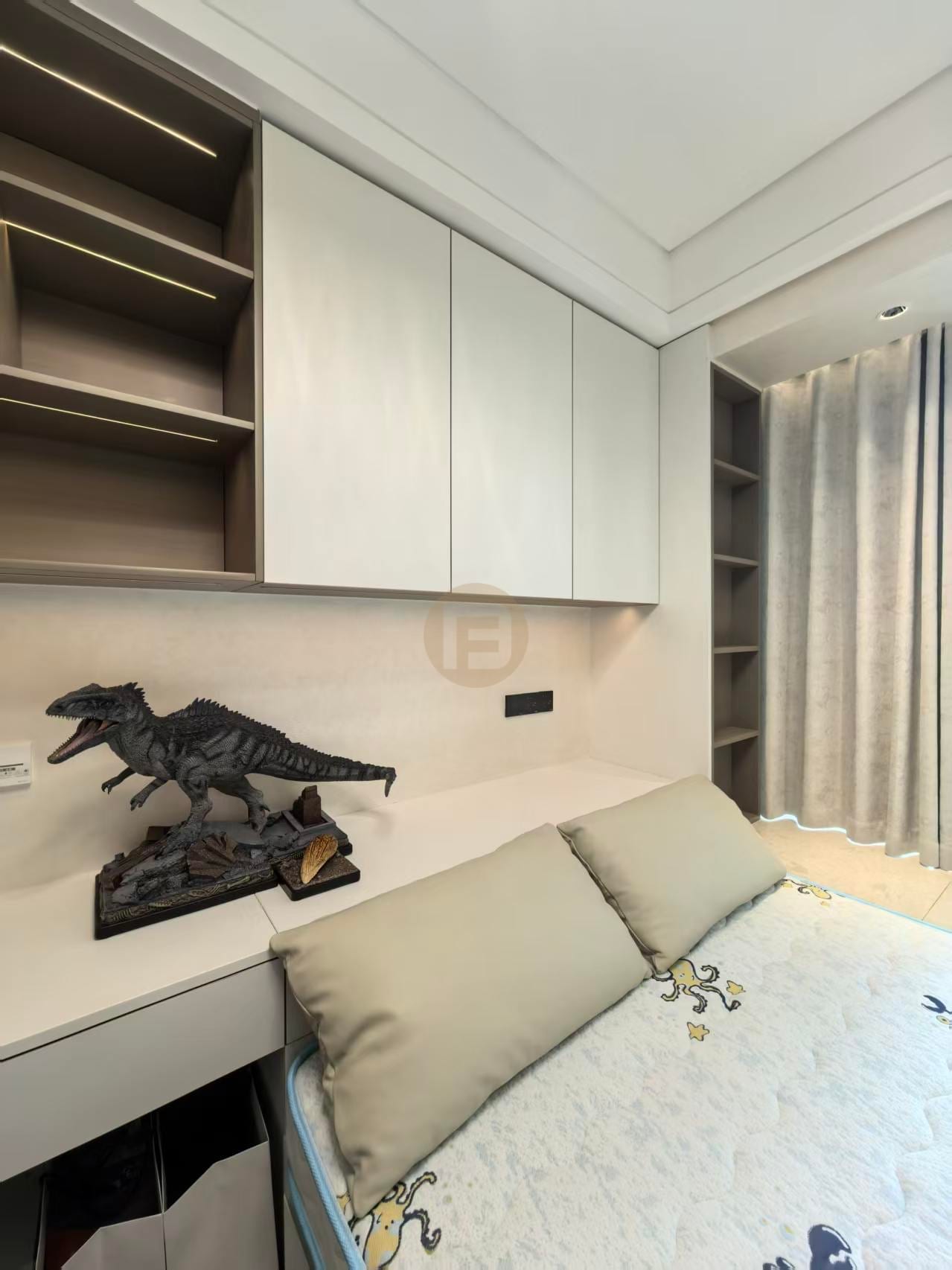 Children's room desk wall with white stainless steel cabinets, open shelving and a dinosaur model