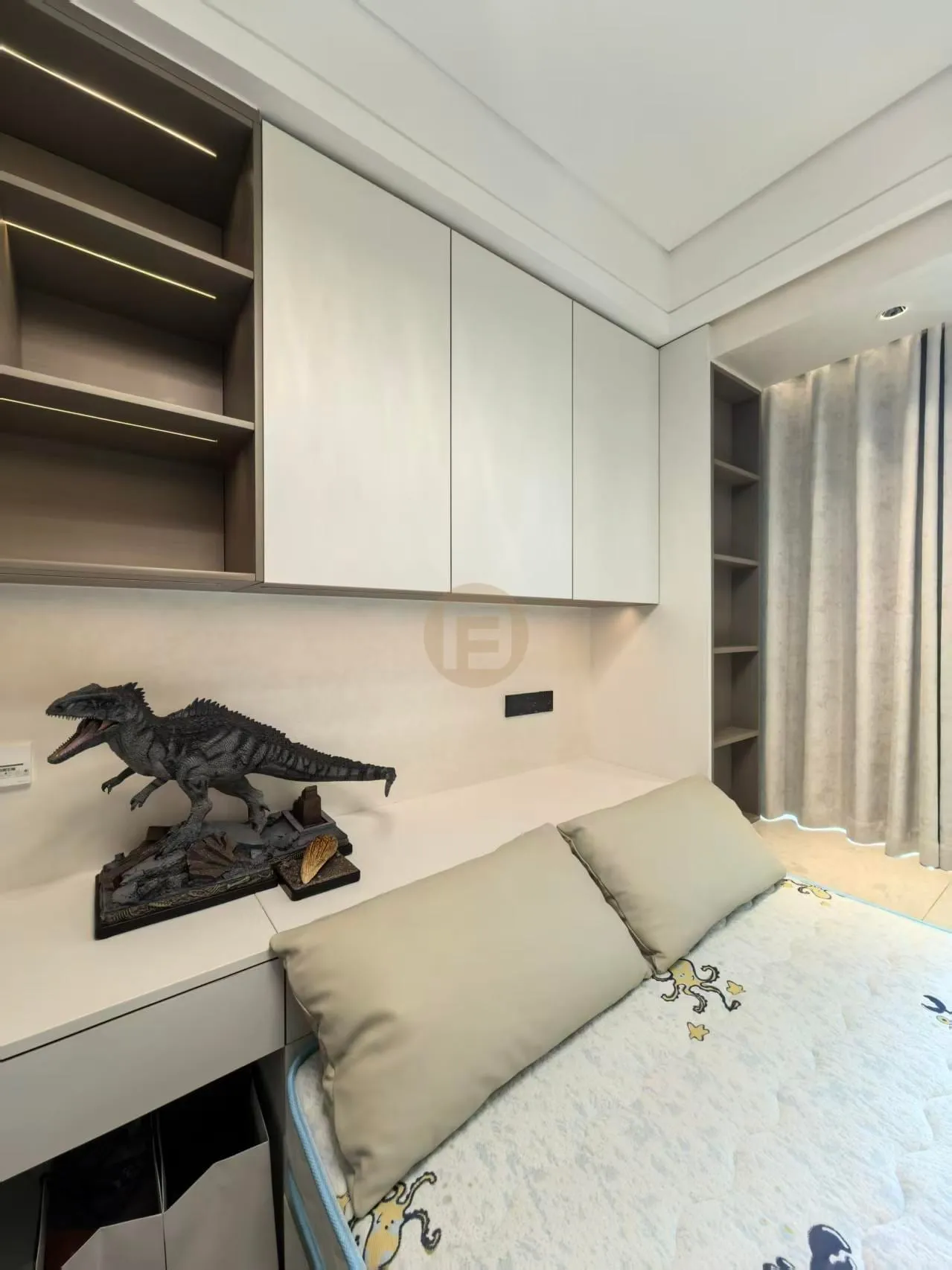 Children's room desk wall with white stainless steel cabinets, open shelving and a dinosaur model