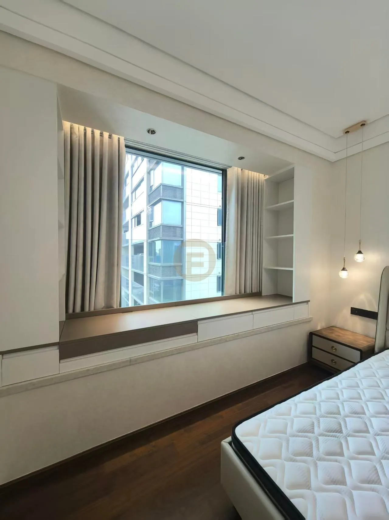 Bedroom bay window with built-in stainless steel storage bench, shelving niche and layered curtains