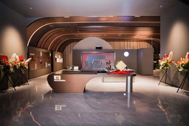 Refined kitchen-like showroom installation with sculpted lighting.