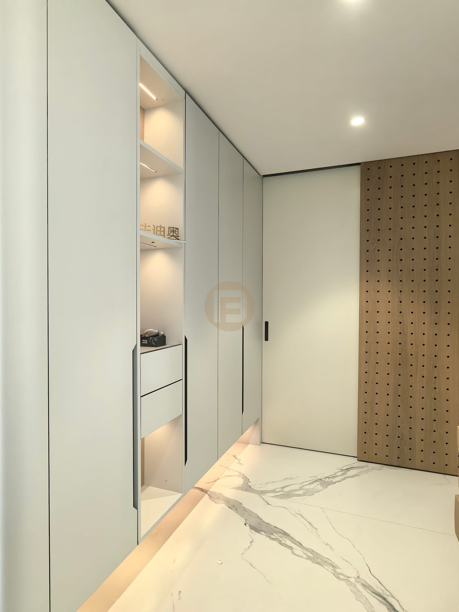 Pale entry cabinetry with a lit display niche and sliding oak pegboard screen