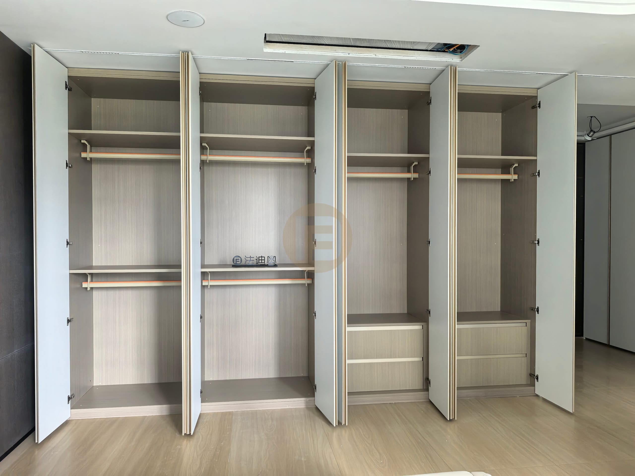 Open white stainless steel wardrobe showing wood-grain interiors, double rails and fitted drawer stacks
