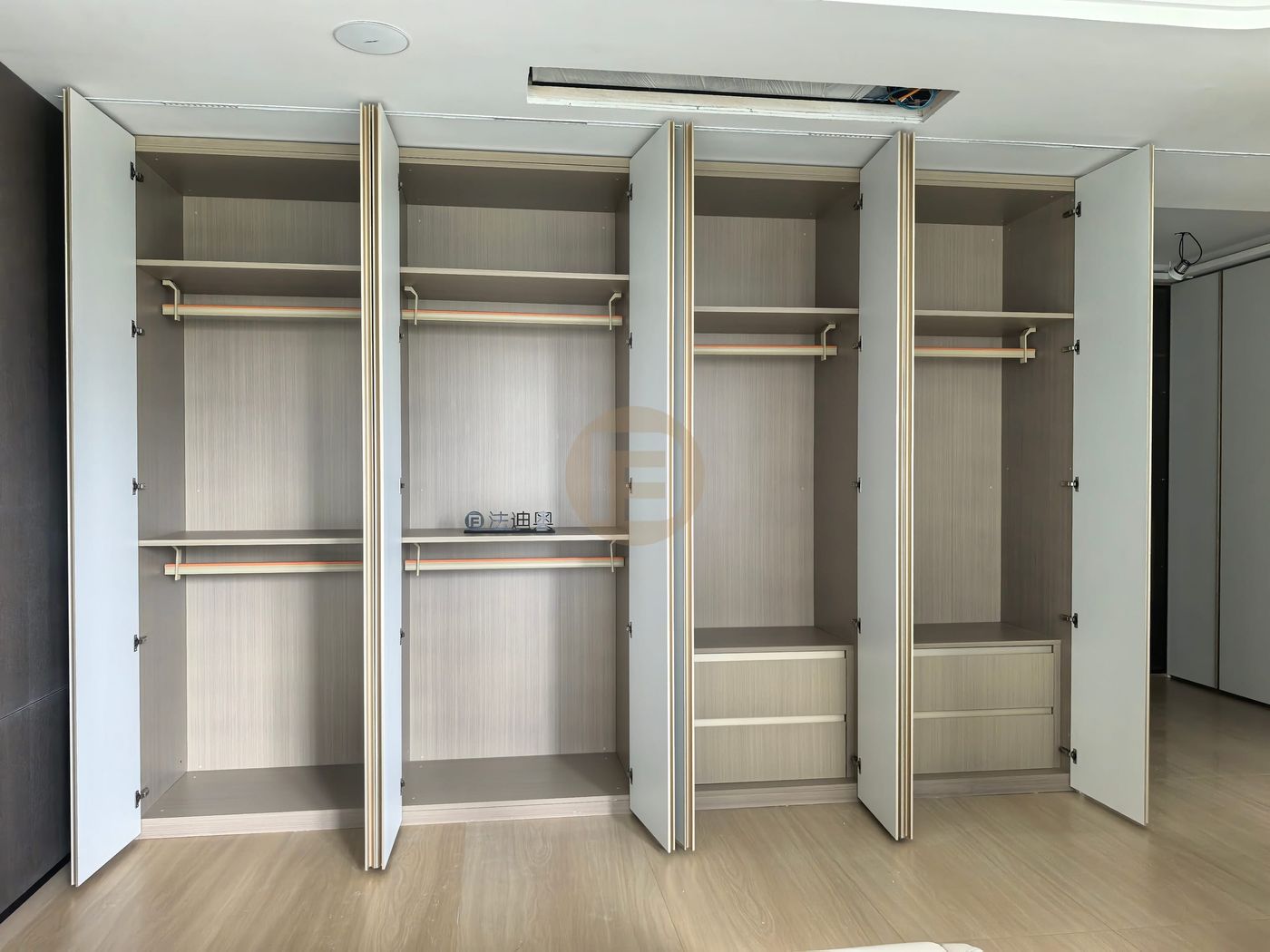 Open white stainless steel wardrobe showing wood-grain interiors, double rails and fitted drawer stacks