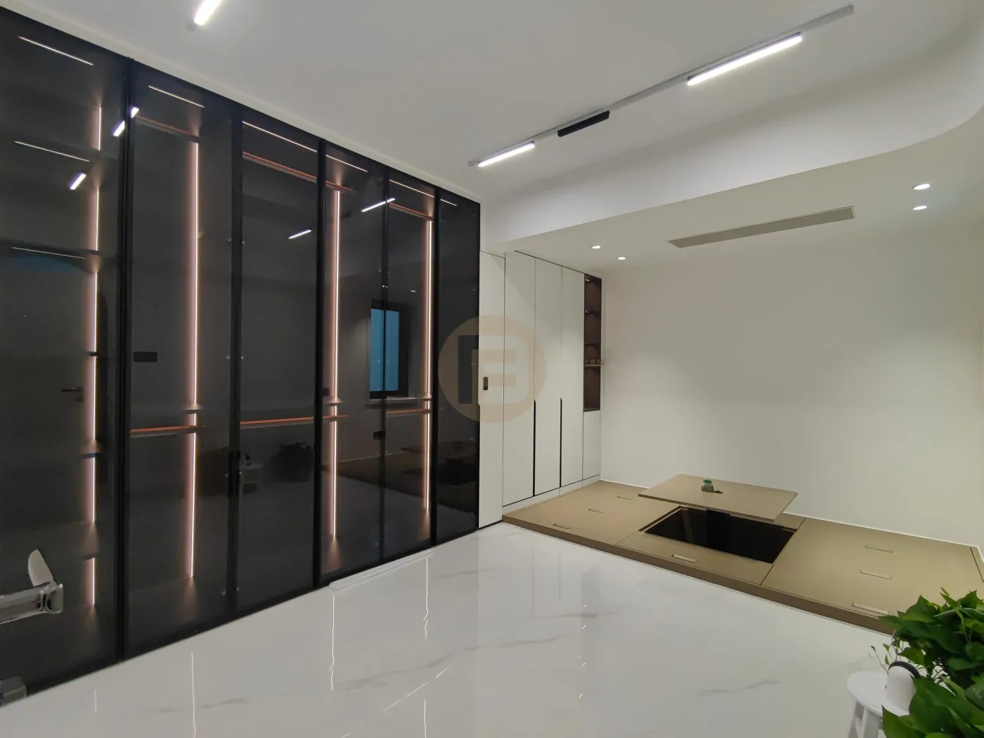 Smoked-glass wardrobe wall with LED edge lighting beside the raised tatami platform