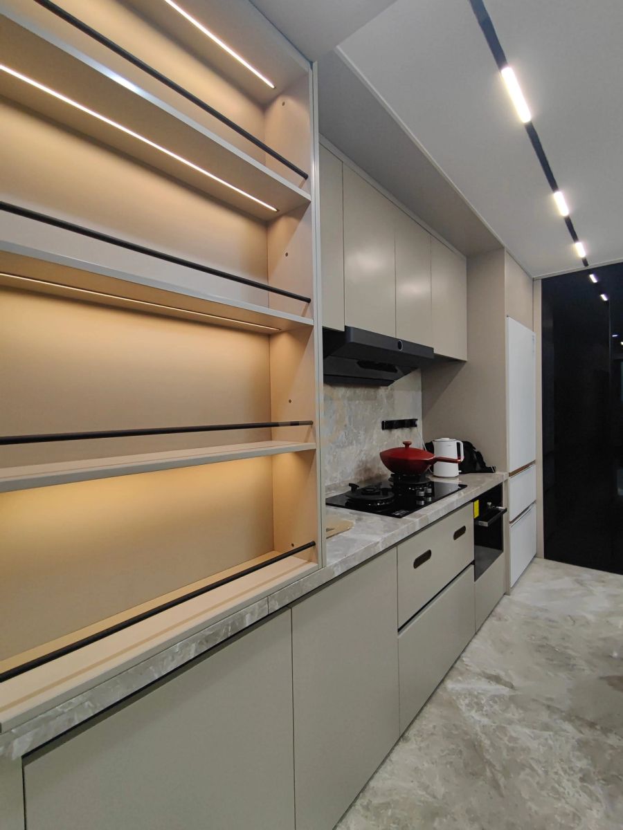 Greige stainless steel kitchen run with backlit open shelving, marble worktop and integrated black hob
