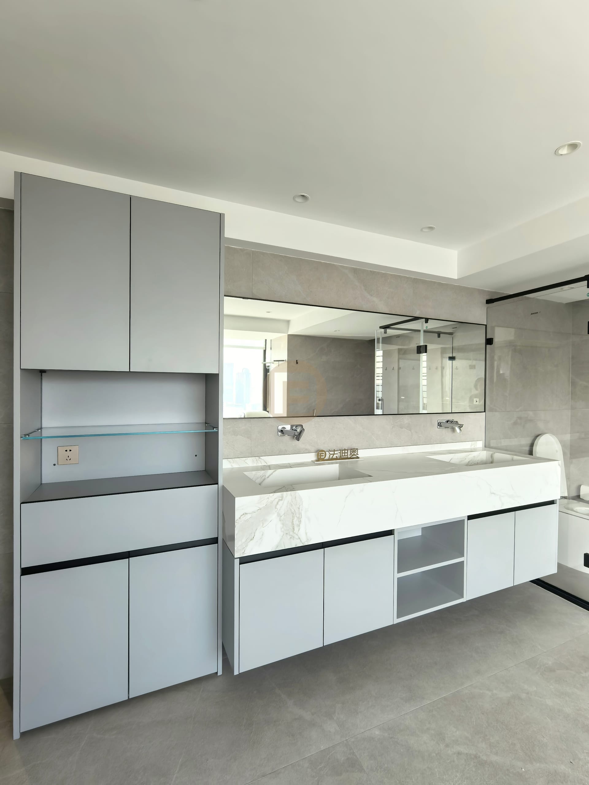 Floating double vanity in grey stainless steel with stone basin deck and tall storage cabinet