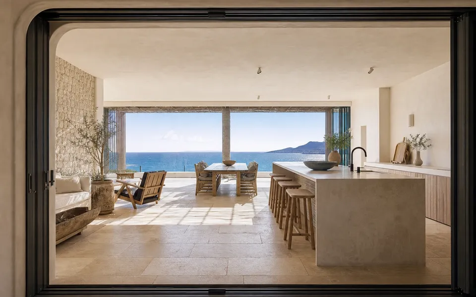 Fadior Cape Town 220 sqm Kitchen Bath Penthouse — Cape Town kitchen island with limestone wall, travertine floor, — 304 stainless steel cabinetry installation by Fadior