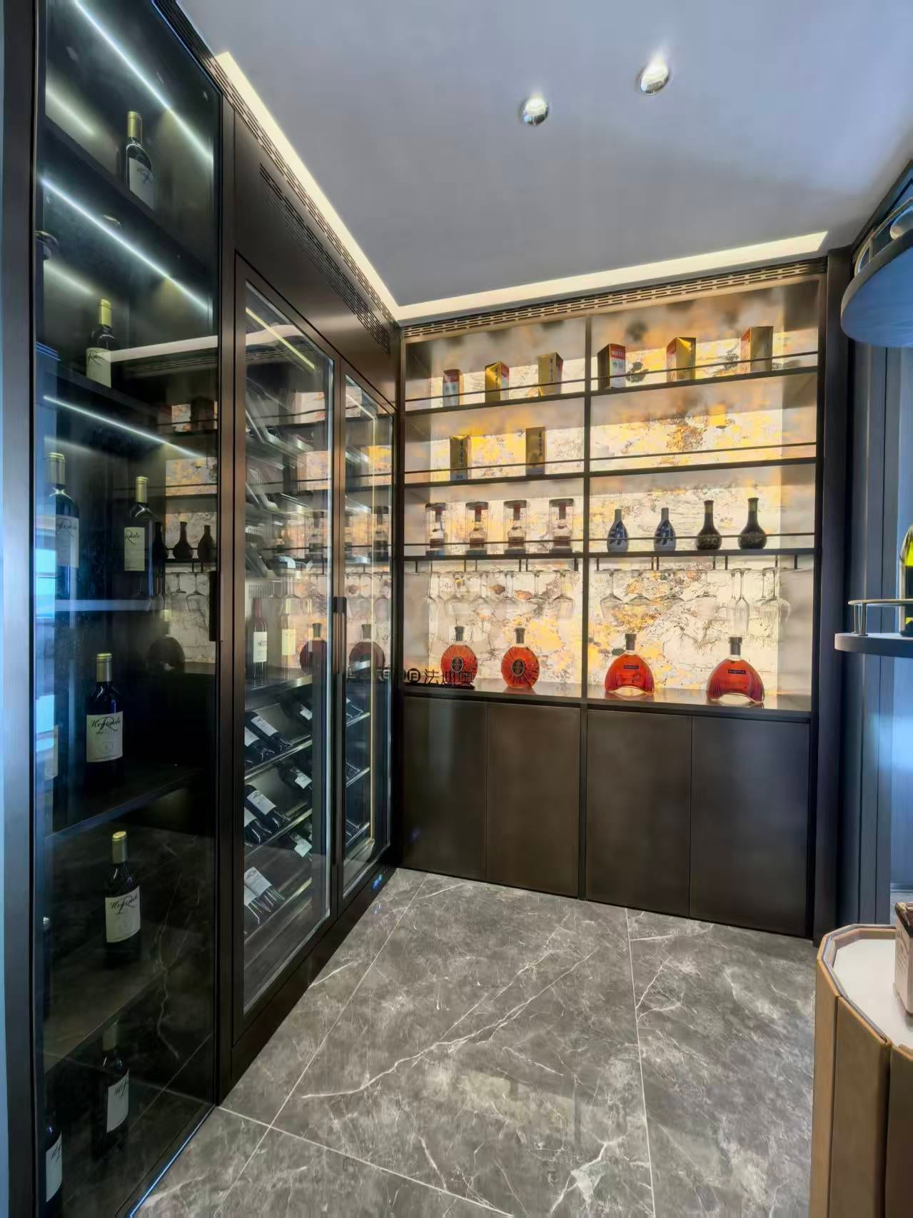 Bar wall with illuminated glass shelving for wine and spirits over bronze-toned base cabinets