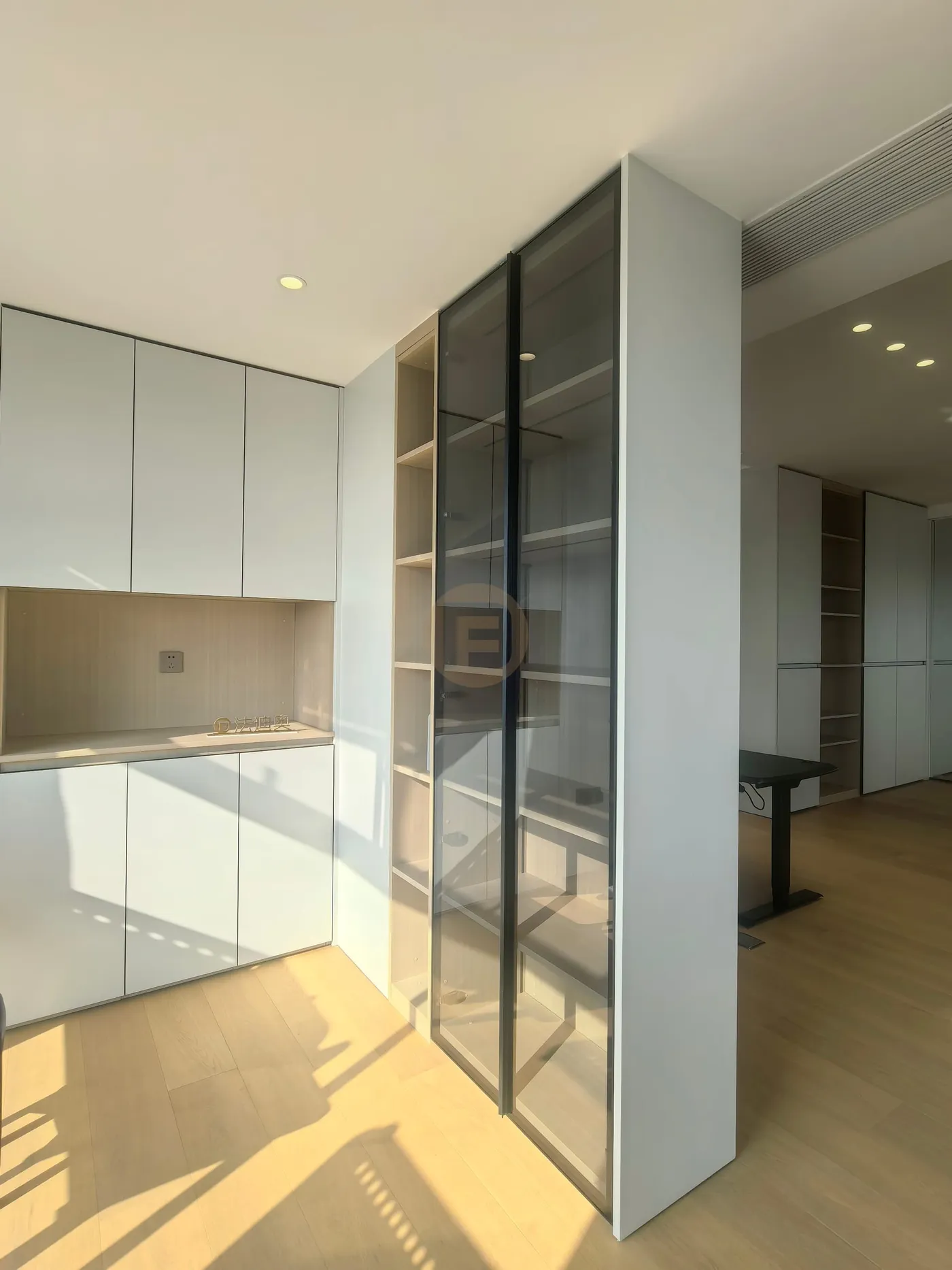 Tea pantry corner with white stainless steel cabinetry and smoked-glass display towers
