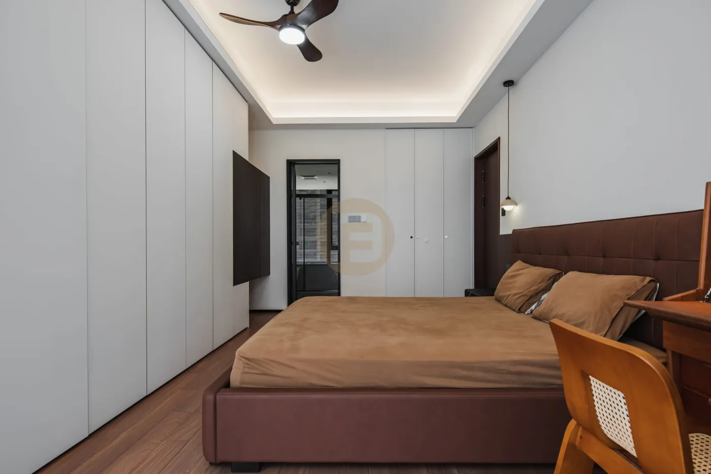 Primary bedroom with full-height white stainless steel wardrobe wall, cove lighting and leather bed