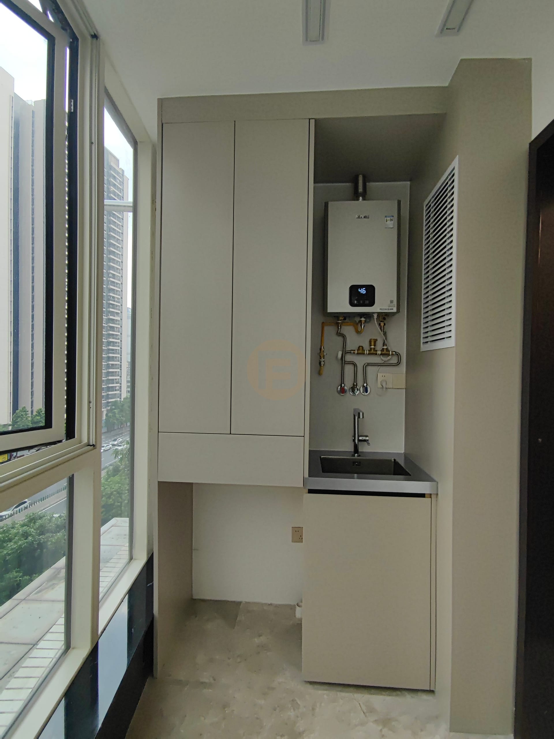 Utility balcony with stainless steel sink unit, tall cabinet and wall-hung boiler by full-height glazing