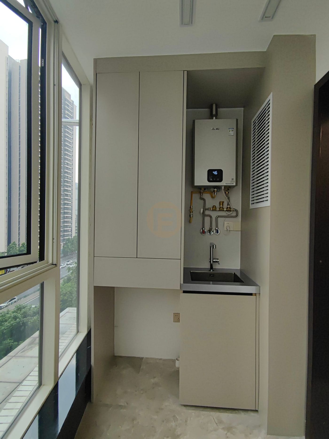 Utility balcony with stainless steel sink unit, tall cabinet and wall-hung boiler by full-height glazing