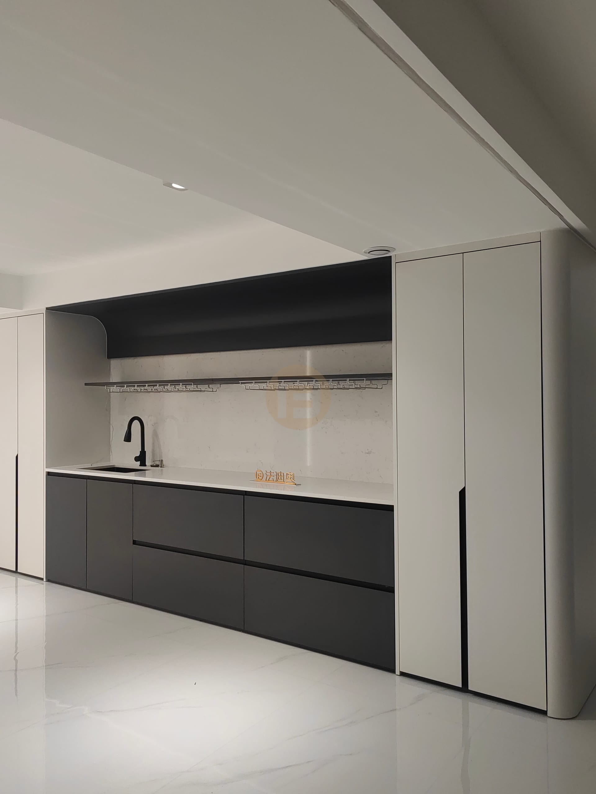Matte black stainless steel bar cabinetry with white counters, wine-glass rail and tall white cabinets