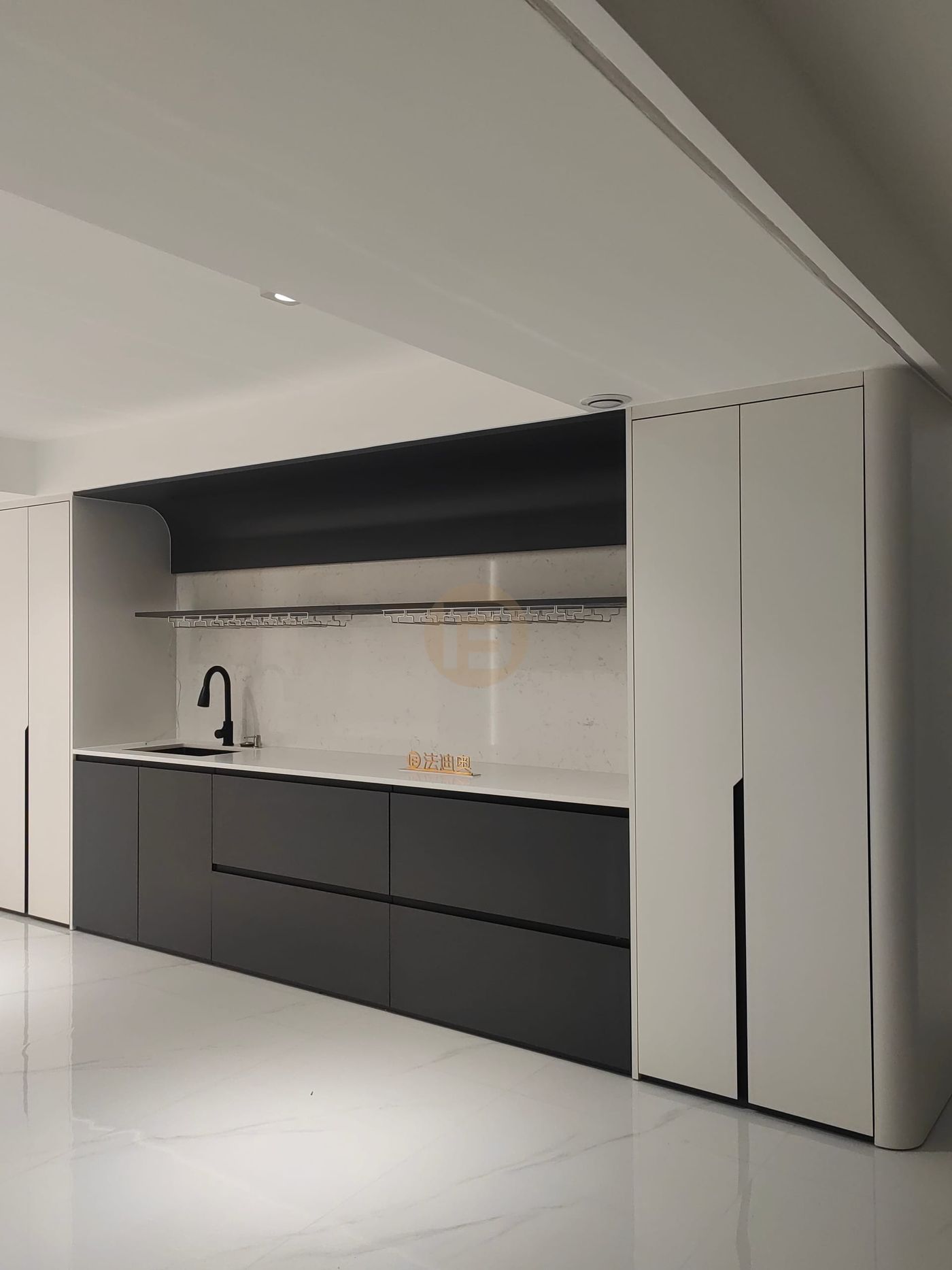 Matte black stainless steel bar cabinetry with white counters, wine-glass rail and tall white cabinets