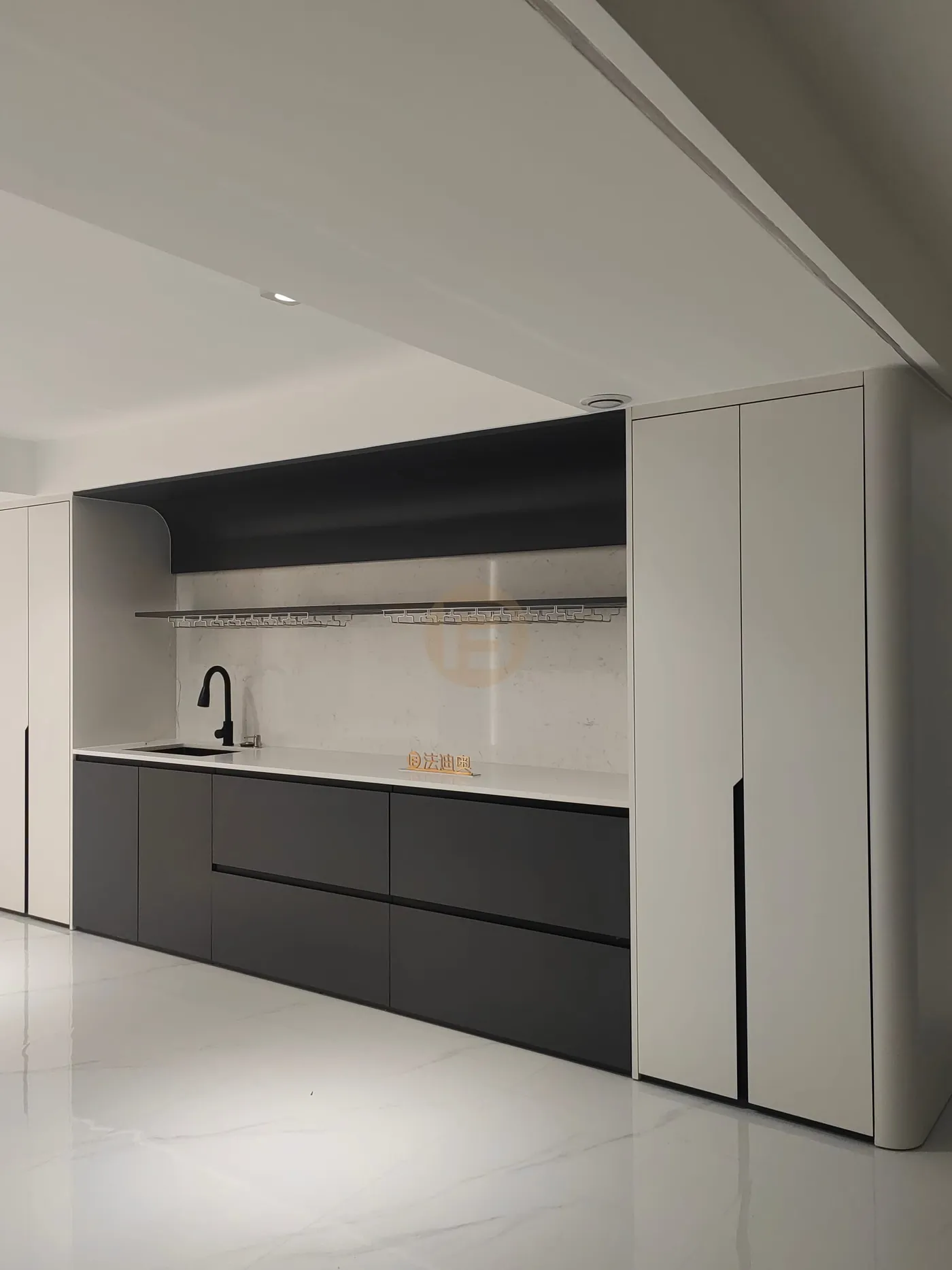 Matte black stainless steel bar cabinetry with white counters, wine-glass rail and tall white cabinets