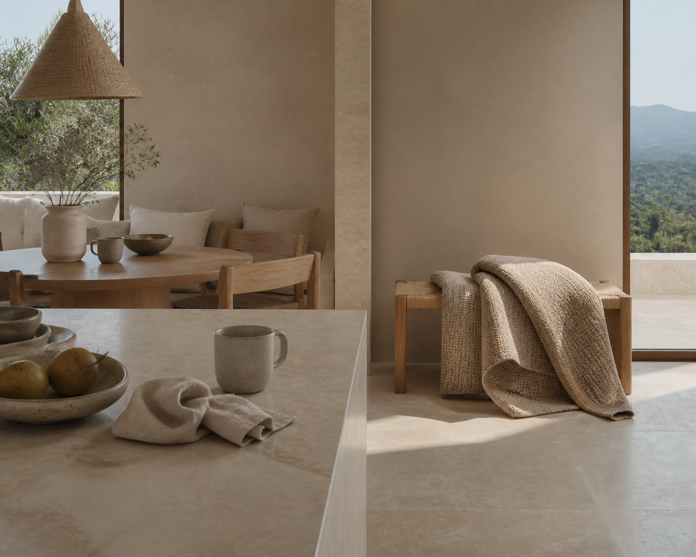 Material study: woven rug on oak bench beside pale stone in a calm kitchen.