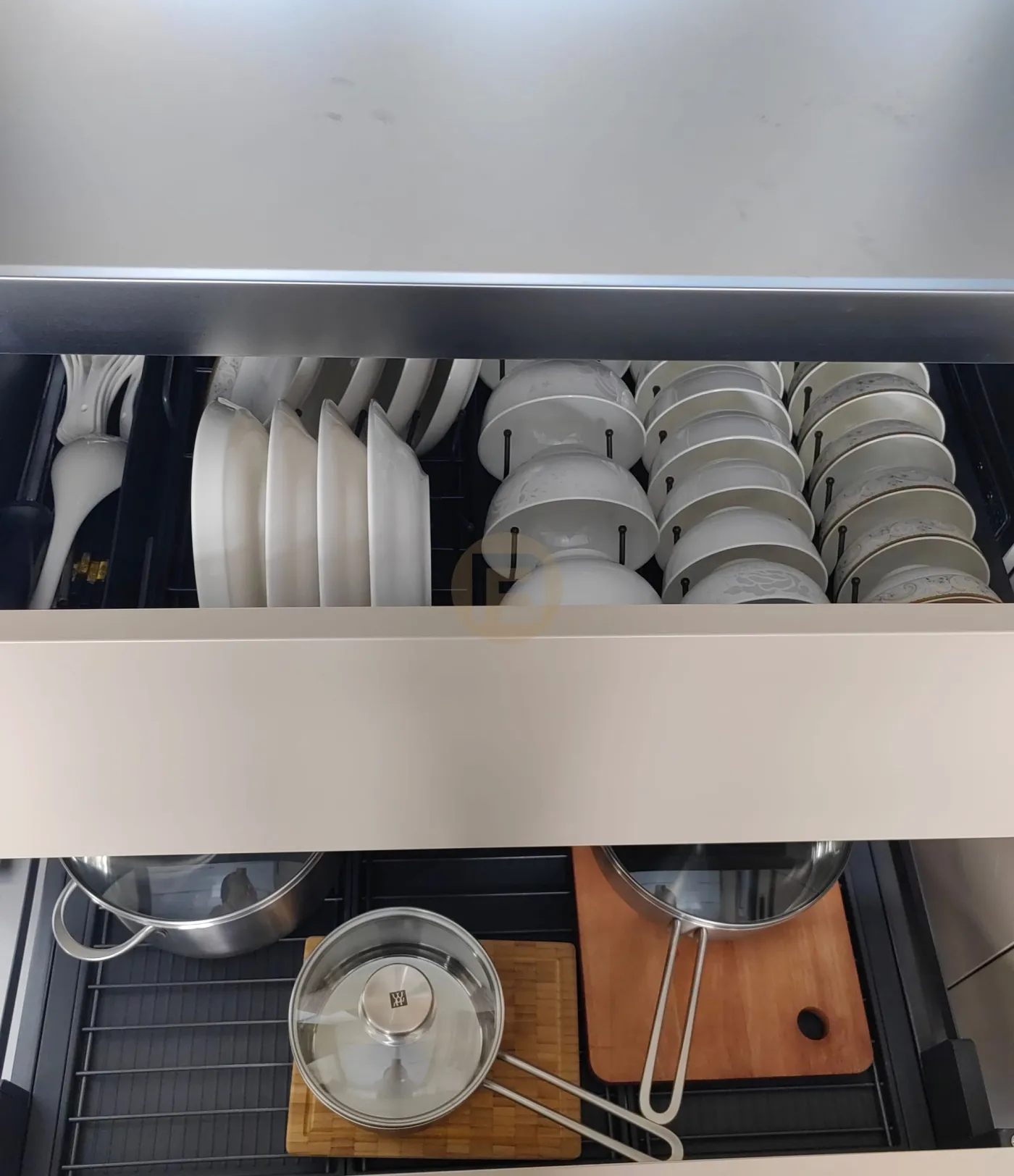 Stainless steel drawer interiors with racks filing plates, bowls and cookware