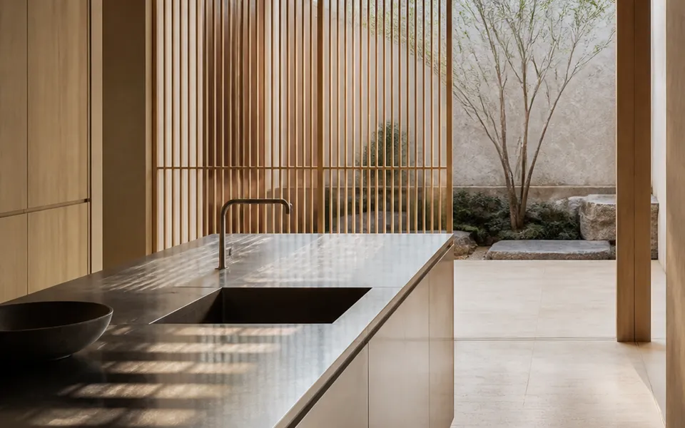 Fadior Tokyo 120 sqm Kitchen Penthouse — brushed steel island, cypress lattice, travertine floor, courtyard tree — 304 stainless steel cabinetry installation by Fadior