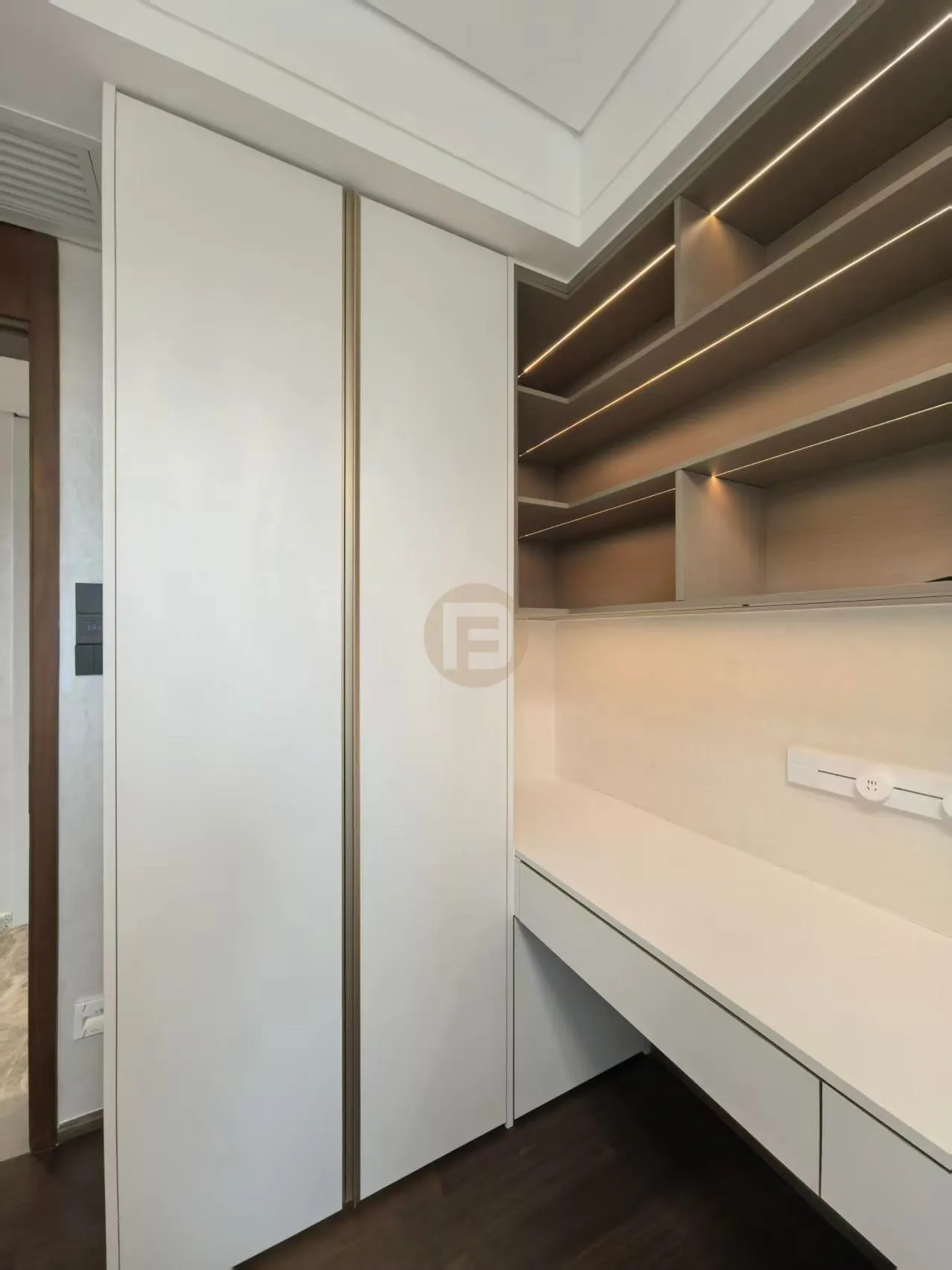 Study corner with white stainless steel wardrobe, floating desk and staggered backlit shelving