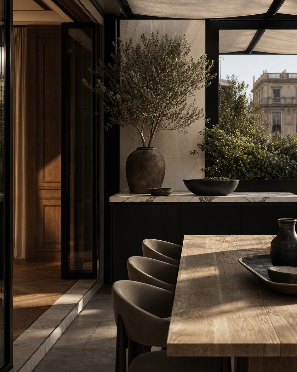 Outdoor kitchen mood study with shaded terrace, walnut threshold, marble serving surface, and khaki dining textiles.